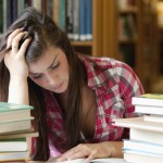 Focused student surrounded by books