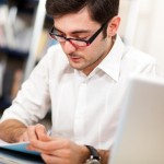 Student reading a book in a library